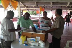 A malaria diagnosis and treatment kit is delivered to a gold mining camp in Suriname. (Photo credit: John Marmion)